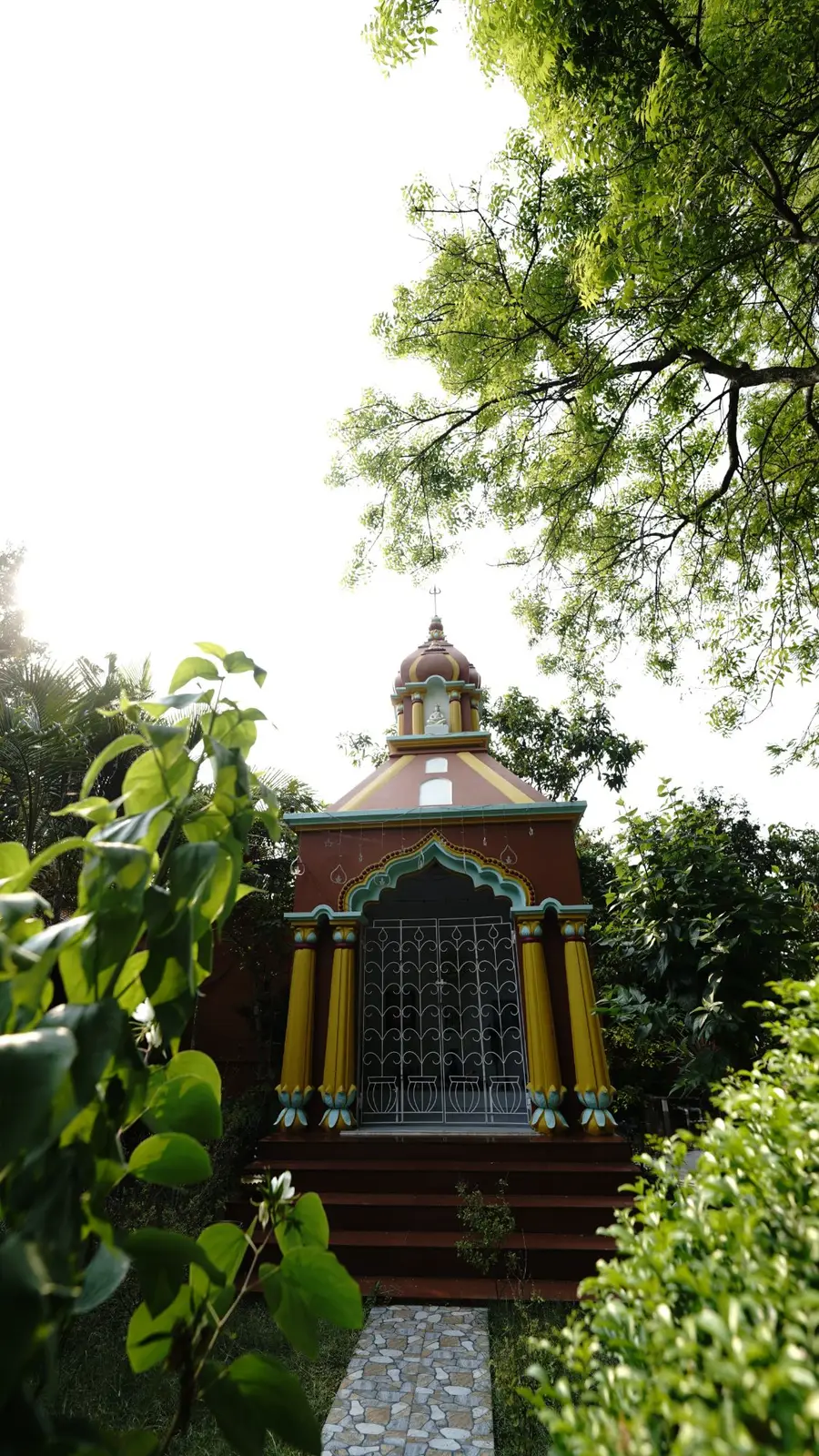 A small temple in the garden at Turiyo, under a spreading tree